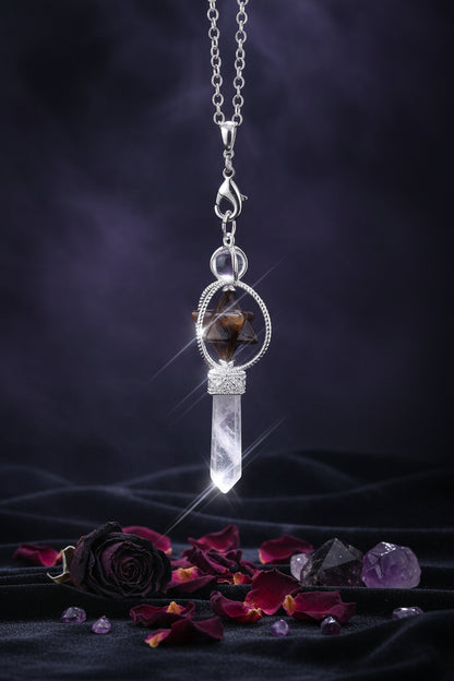 Jewelry set with a star-shaped pendant and crystal-like element on a black background