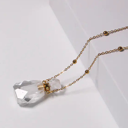 Crystal necklace with gold chain on a white background