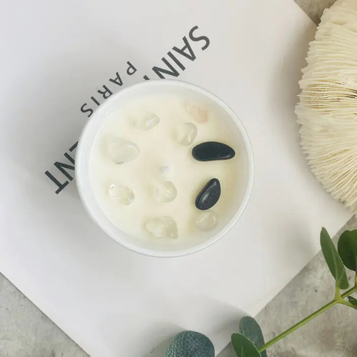 Cosmetic container with black stones on a white background