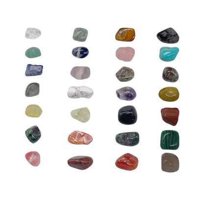 Assorted tumbled gemstones on a white background