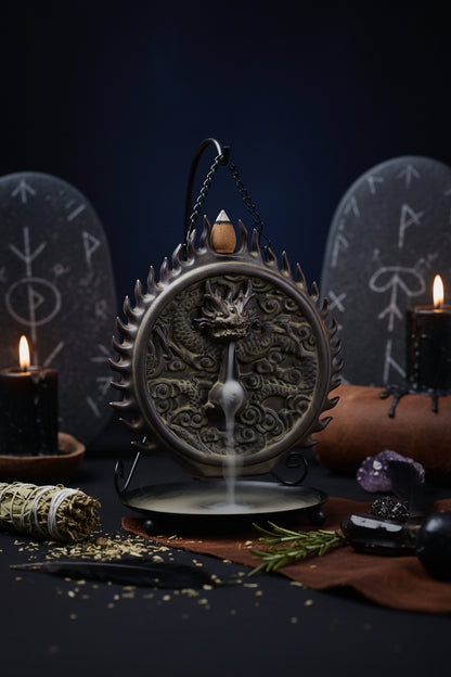 Decorative incense burner with dragon design on a black background