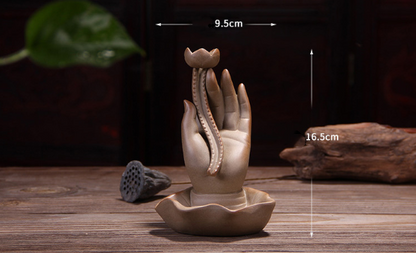 Ceramic hand sculpture with measurements on a wooden surface