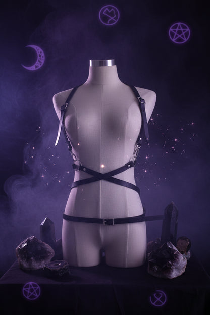 Black leather harness on a mannequin against a plain background