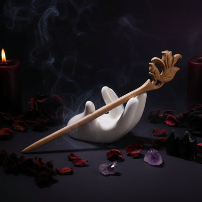 Wooden hair stick with decorative design on a white background