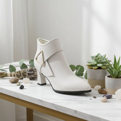 White ankle boot with a geometric design on a white background
