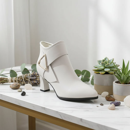 White ankle boot with a geometric design on a white background