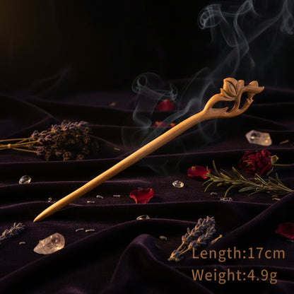 Wooden hair stick with floral design on a white background