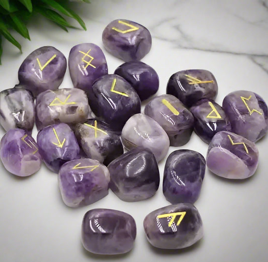 Purple stones with yellow runes on a white background