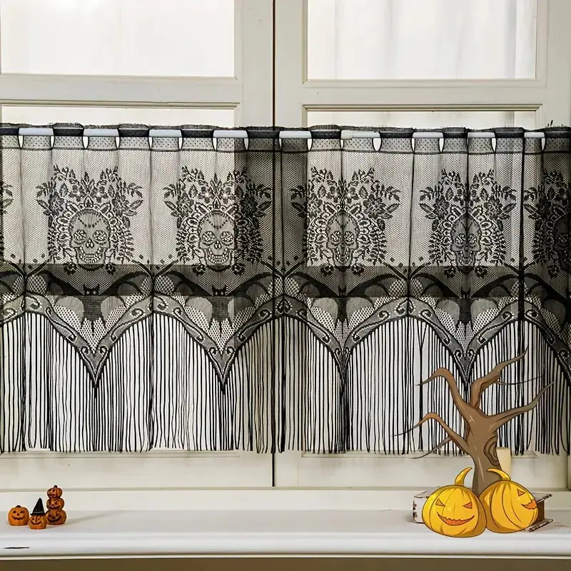 Decorative black lace curtain with skull patterns in front of a window.