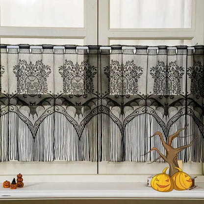 Decorative black lace curtain with skull patterns in front of a window.