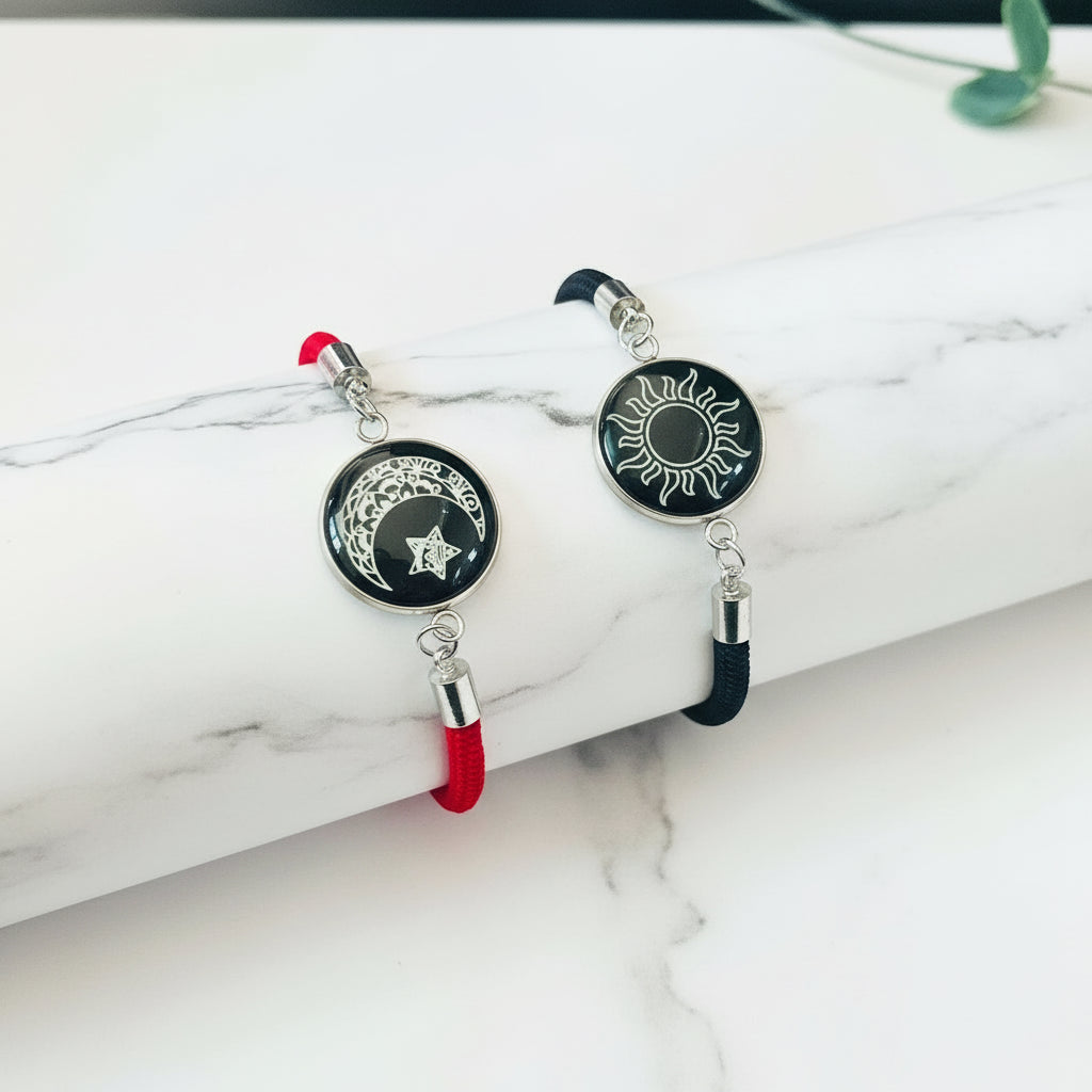 Pair of earrings with sun and moon designs on a white surface