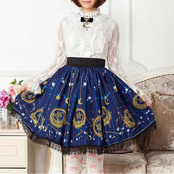 Person wearing a blue skirt with gold patterns and a white lace top.