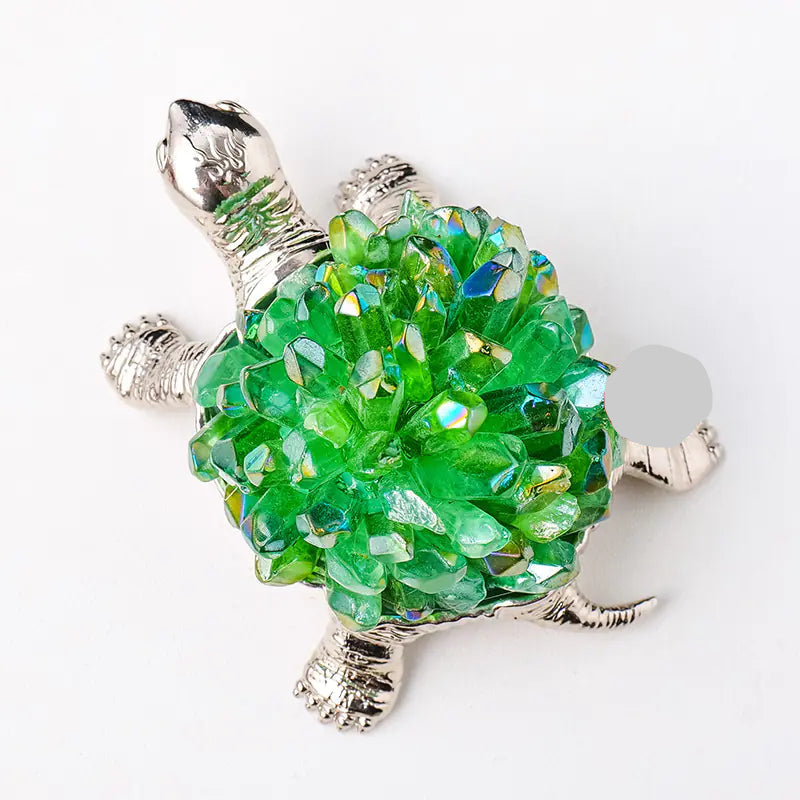 Tortoise-shaped object with purple crystal-like material on a white background