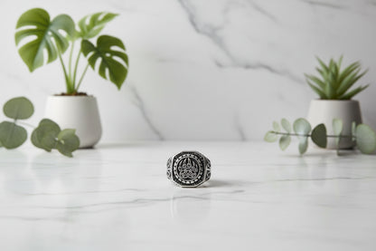 Silver ring with paw print design on a white background