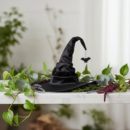 Black witch hat with a hanging bat on a white background
