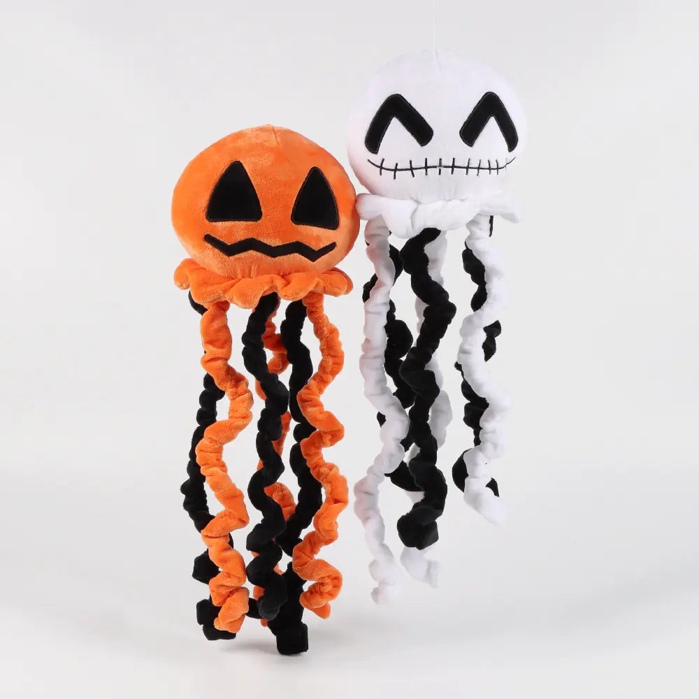 Two Halloween-themed headbands, one orange with black jack-o'-lantern face and the other white with black ghost design, on a white background.