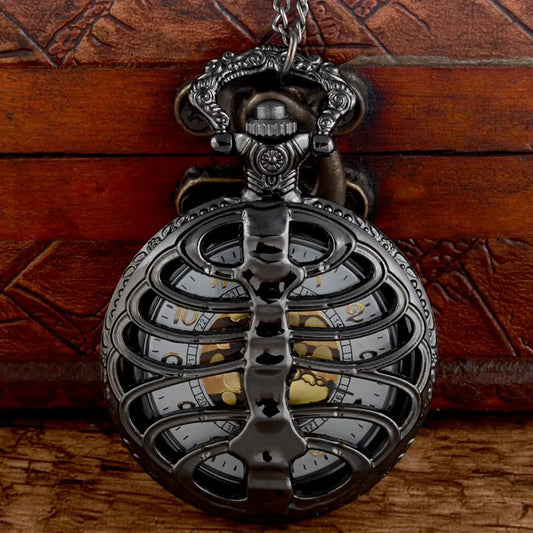 Vintage pocket watch with intricate design on a wooden background
