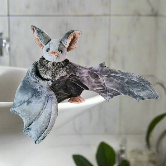 Plush toy bat with gray wings and brown head on a white background