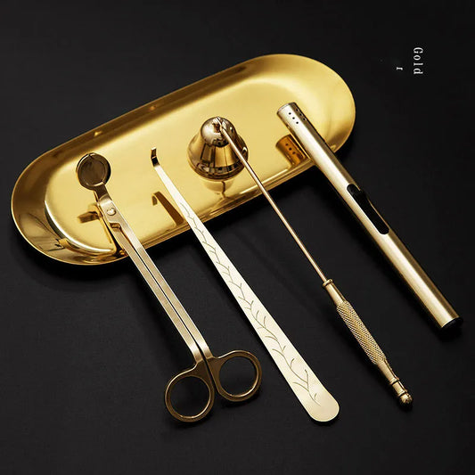 Set of gold candle tools on a black background