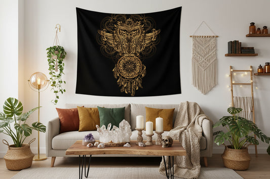 Decorative tapestry with owl design on a black background, placed on a wooden floor with plants and a colorful pillow.