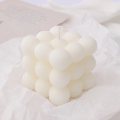 White bubble candle on a white fabric background