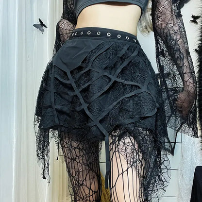 Person wearing a black lace skirt with spider web design and sheer stockings.