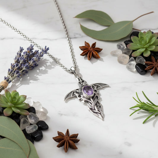 Silver pendant with a purple gemstone on a white background