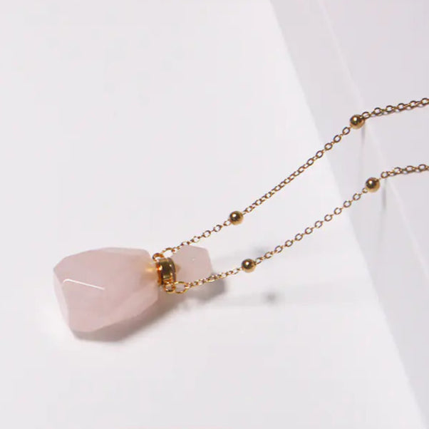 Necklace with pink crystal pendant on a white background