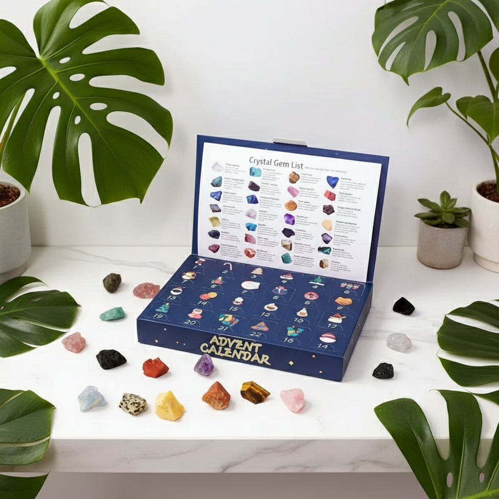 Advent calendar with crystal gems and a hand holding a green gemstone.