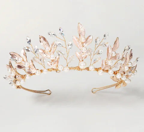 Rose gold tiara with pearls and crystals on a light gray background