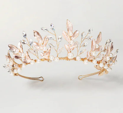 Rose gold tiara with pearls and crystals on a light gray background