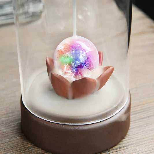 Decorative item with a colorful sphere inside a glass dome on a wooden surface