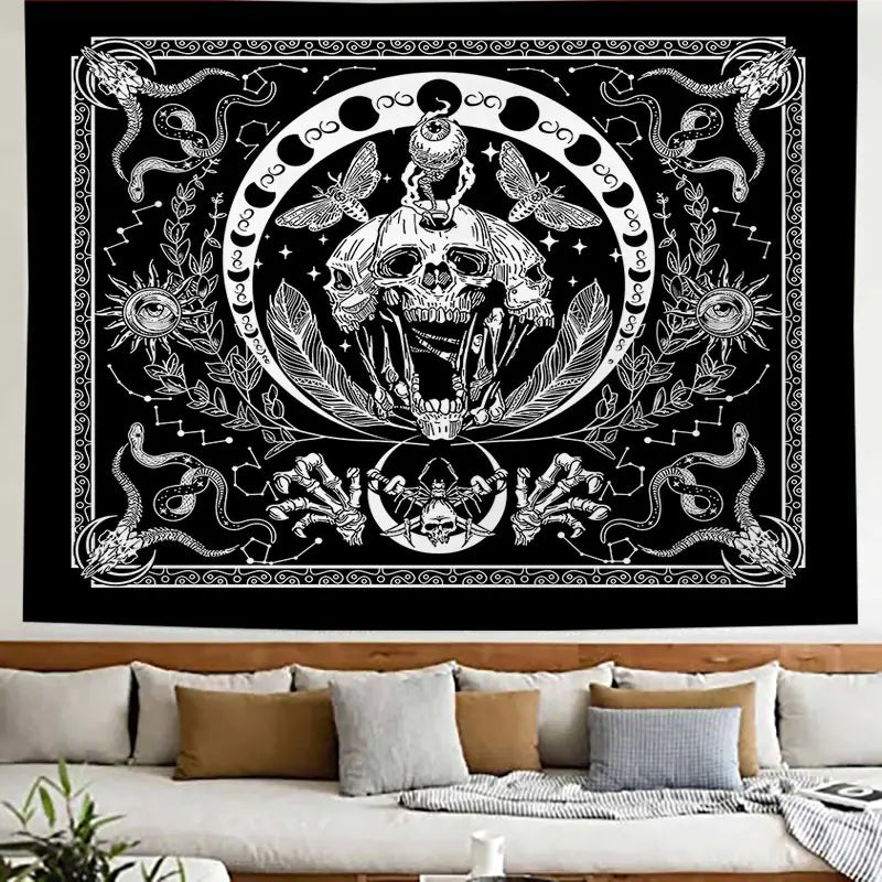Decorative tapestry with skull and snake design on a wall above a sofa.