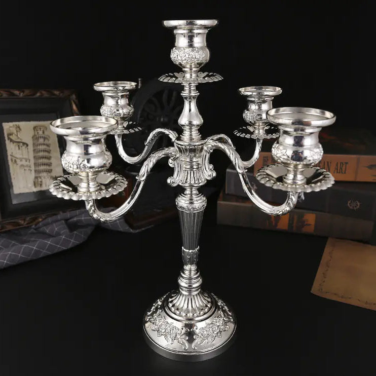 Silver candelabra on a dark surface with text indicating dimensions and weight.