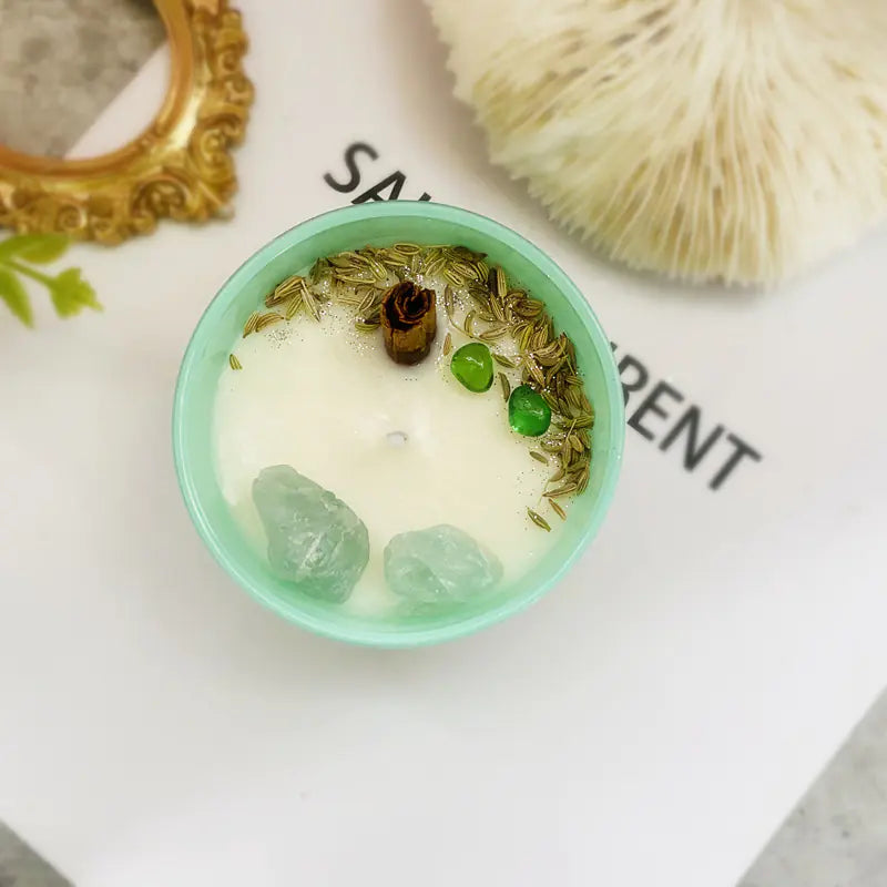 Candle with decorative elements on a white surface