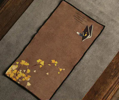 Brown mat with autumn design on a gray carpet
