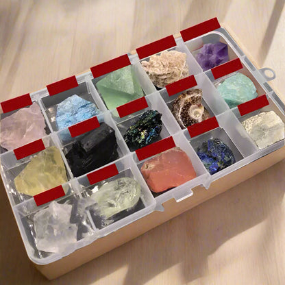 Collection of various colorful crystals in a clear storage box with red lids.