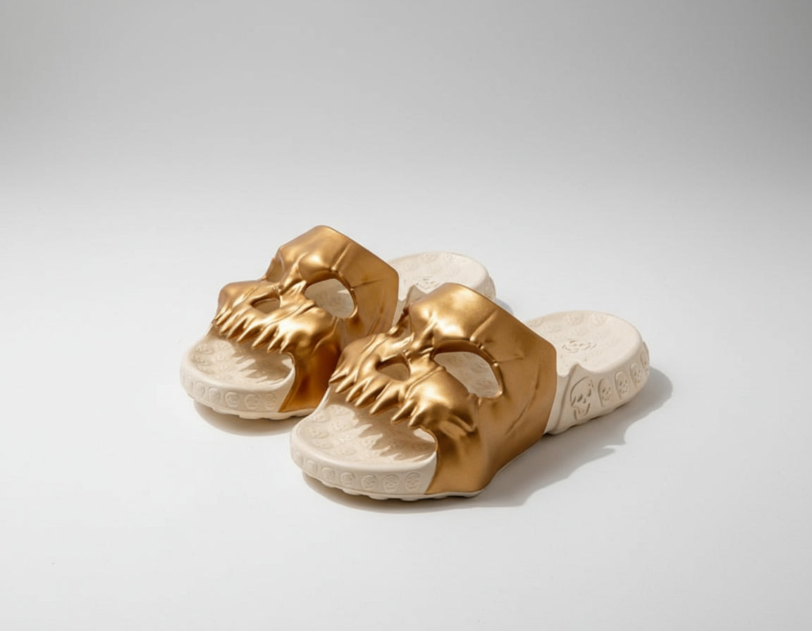 Gold dragon head sandals on a white background