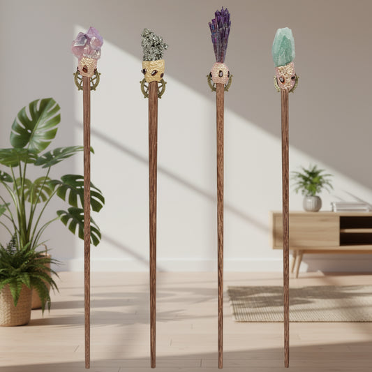 Four decorative magic wands with gemstone tops on a white background