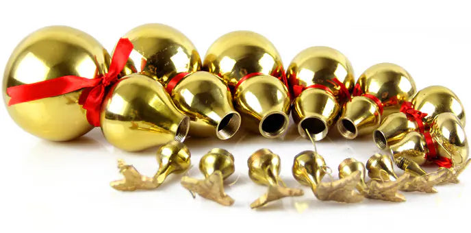 Gold jingle bells with red ribbons on a white background