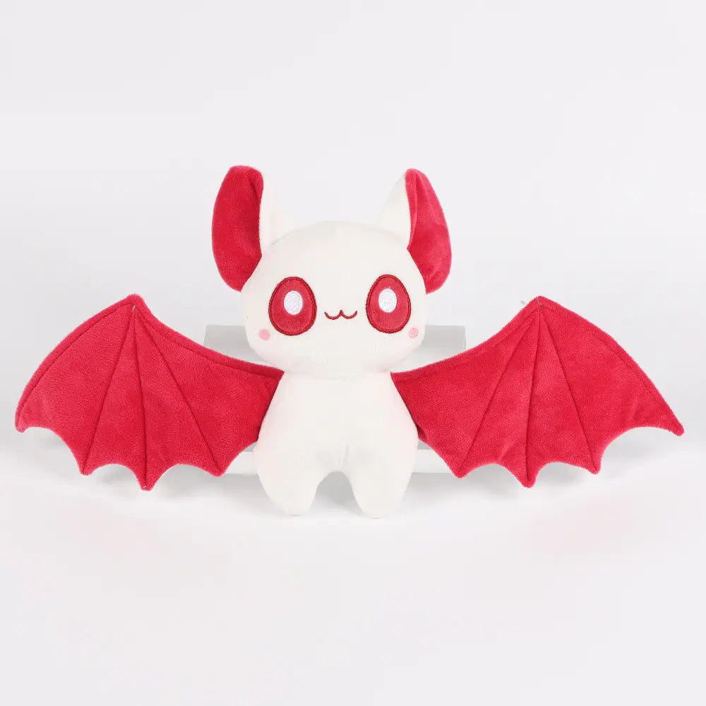 Plush toy with red wings on a white background