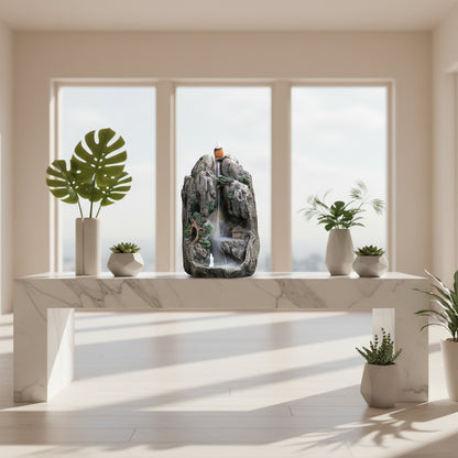 Decorative rock fountain with waterfall on a white background